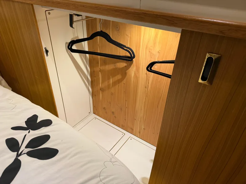 Slide: The Image of Wooden closet with hangers inside a 2001 Bayliner 5288 Pilot House Motoryacht. - 46