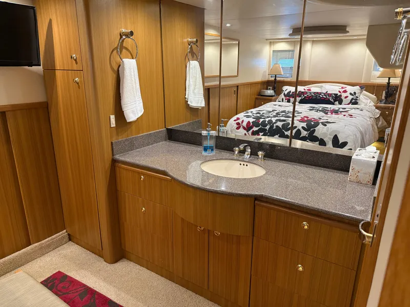 Slide: The Image of Luxurious bathroom and bedroom in 2001 Bayliner 5288 Pilot House Motoryacht, featuring wood cabinetry. - 49