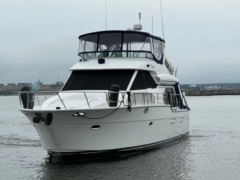 Slide: The Image of 2001 Bayliner 5288 Pilot House Motoryacht on calm water, overcast sky. - 5