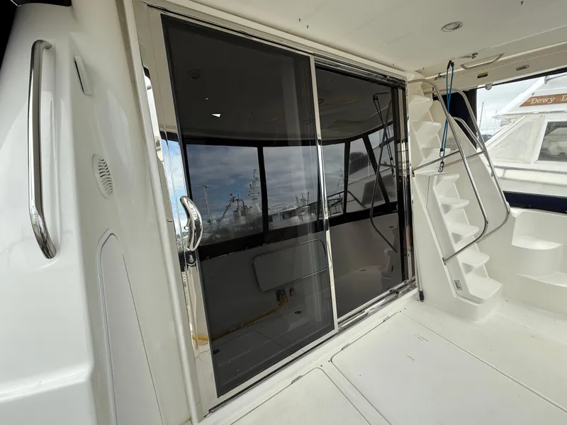 Slide: The Image of 2001 Bayliner 5288 Pilot House Motoryacht with sliding glass doors and exterior stairs. - 8