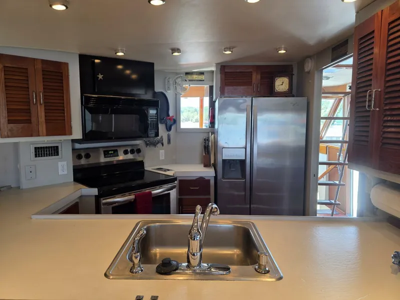 Slide: The Image of Modern kitchen interior on 1976 Chris-Craft Roamer 60 yacht with stainless steel appliances. - 28