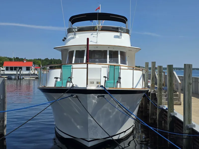 Slide: The Image of 1976 Chris-Craft Roamer 60 yacht docked at a marina on a sunny day. - 3