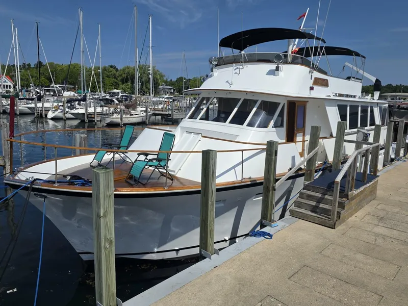 Slide: The Image of 1976 Chris-Craft Roamer 60 yacht docked at a marina on a sunny day. - 4