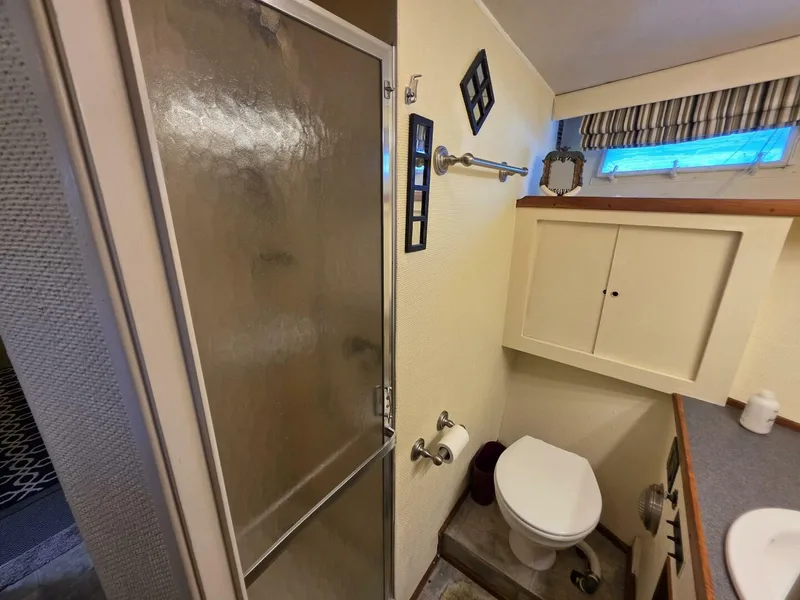 Slide: The Image of Bathroom interior of 1976 Chris-Craft Roamer 60 yacht with shower and toilet. - 42