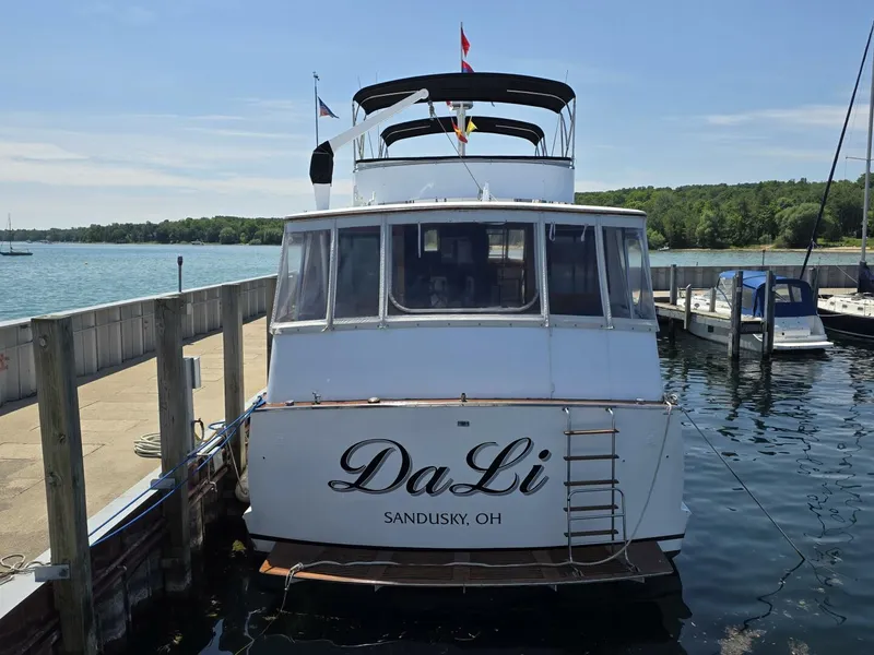 Slide: The Image of 1976 Chris-Craft Roamer 60 yacht docked, rear view, with "DaLi" and Sandusky, OH lettering. - 5