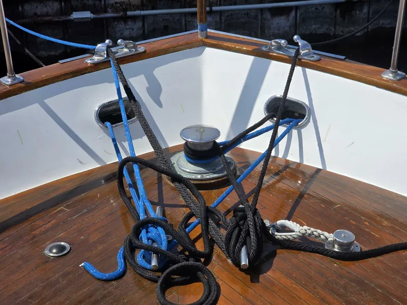 Slide: The Image of Bow of 1976 Chris-Craft Roamer 60 with ropes and cleats on wooden deck. - 7