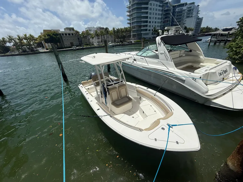 Slide: The Image of 2017 Sea Fox 226 Commander boat docked beside a larger yacht in a marina. - 5