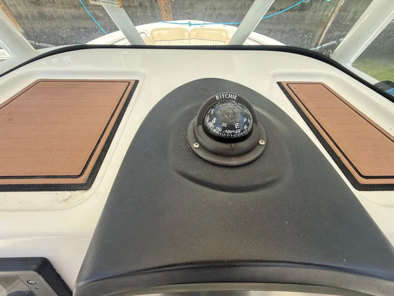 Slide: The Image of Compass on 2017 Sea Fox 226 Commander boat dashboard, featuring wood panel accents. - 8