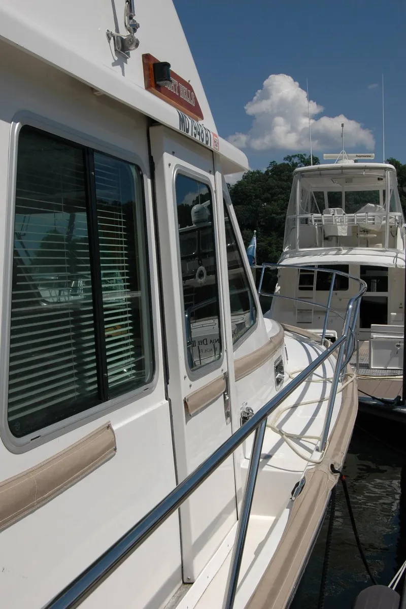 Slide: The Image of 2006 Sabre 36 Flybridge Sedan docked, showcasing sleek design and spacious deck. - 19