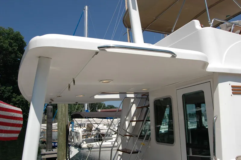Slide: The Image of 2006 Sabre 36 Flybridge Sedan yacht with ladder and shaded deck area. - 21