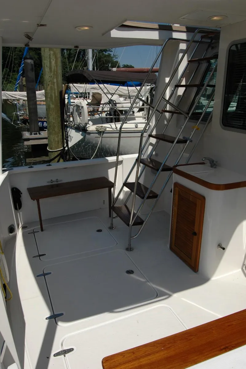 Slide: The Image of 2006 Sabre 36 Flybridge Sedan boat deck with ladder and seating area. - 24