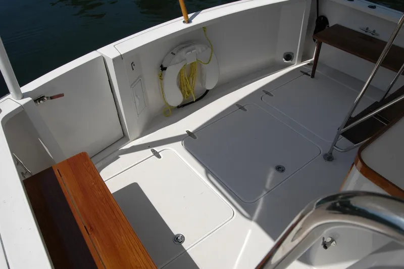 Slide: The Image of 2006 Sabre 36 Flybridge Sedan deck with wooden seating and life preserver. - 26