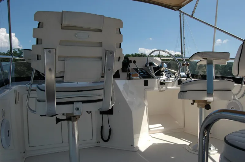 Slide: The Image of 2006 Sabre 36 Flybridge Sedan helm with dual captain chairs and steering wheel. - 29
