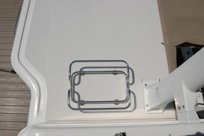 Slide: The Image of 2006 Sabre 36 Flybridge Sedan deck with metal railing and beige cover. - 32