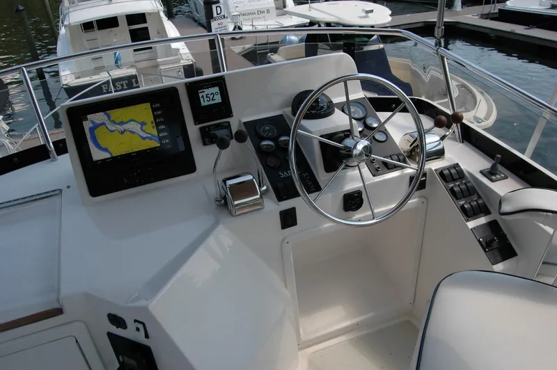 Slide: The Image of 2006 Sabre 36 Flybridge Sedan helm with navigation display and steering wheel. - 34
