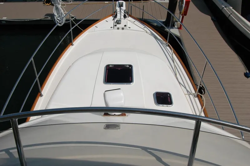 Slide: The Image of 2006 Sabre 36 Flybridge Sedan boat deck with hatches and railing, docked at marina. - 43