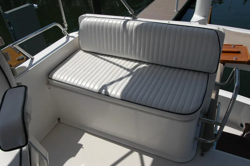 Slide: The Image of White cushioned seating on 2006 Sabre 36 Flybridge Sedan boat deck. - 44