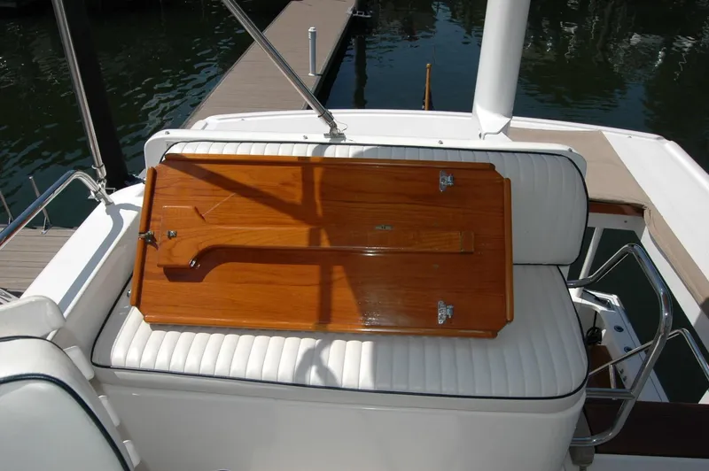 Slide: The Image of 2006 Sabre 36 Flybridge Sedan with wooden table on white cushioned seating. - 45
