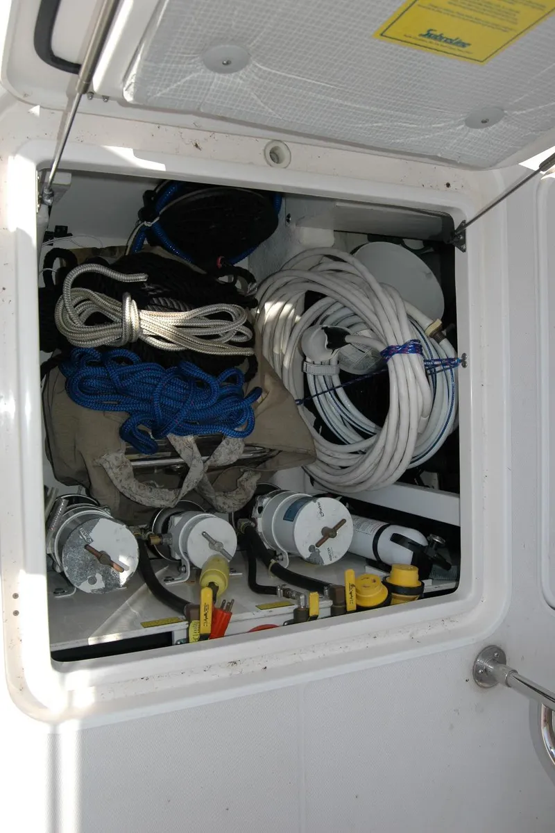 Slide: The Image of Storage compartment on a 2006 Sabre 36 Flybridge Sedan with ropes and equipment. - 49