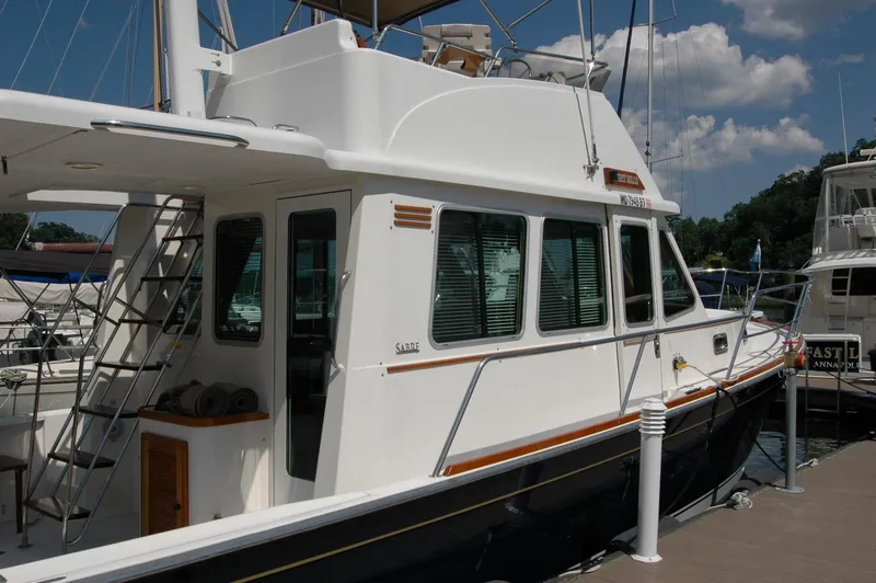Slide: The Image of 2006 Sabre 36 Flybridge Sedan docked at marina under clear sky. - 6