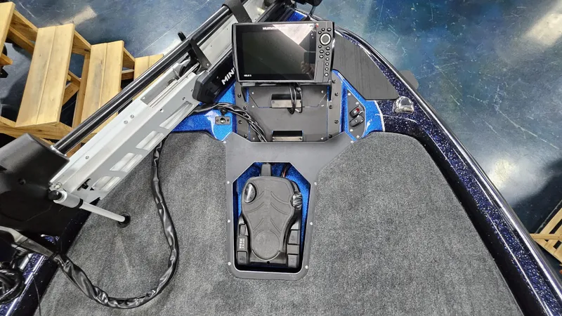 Slide: The Image of 2025 Skeeter ZXR 21 boat dashboard with electronic controls and display screen. - 16