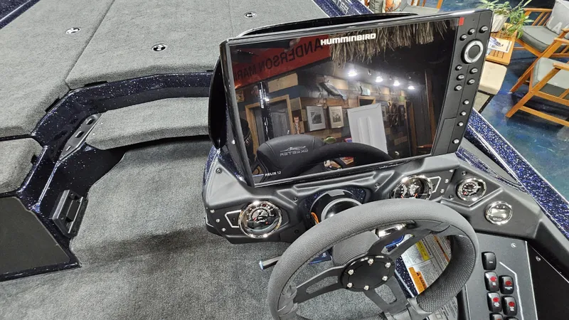 Slide: The Image of 2025 Skeeter ZXR 21 boat dashboard with Humminbird display and steering wheel. - 19