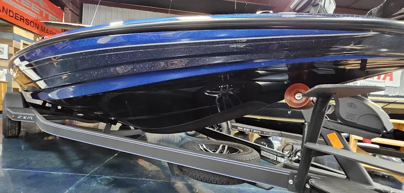 Slide: The Image of 2025 Skeeter ZXR 21 boat on trailer, showcasing sleek blue hull design. - 20