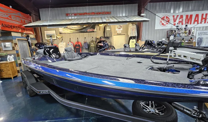Slide: The Image of 2025 Skeeter ZXR 21 boat displayed in showroom with Yamaha and Skeeter banners. - 23