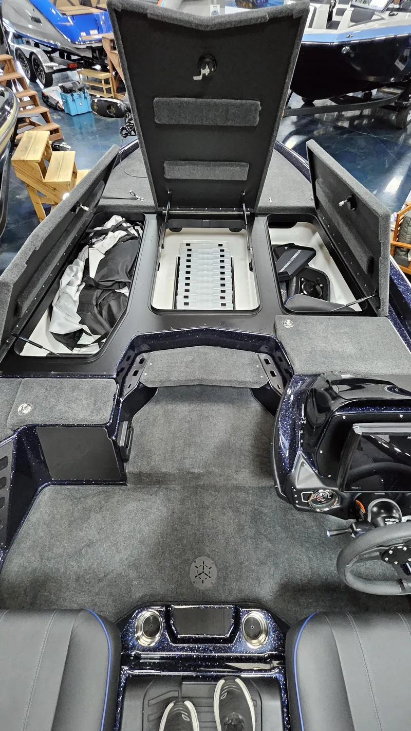 Slide: The Image of 2025 Skeeter ZXR 21 boat interior with open storage compartments and steering console. - 25
