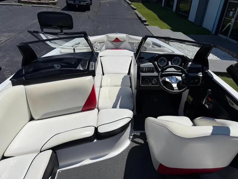 Slide: The Image of 2011 Axis A22 boat interior with white seating and modern dashboard. - 10