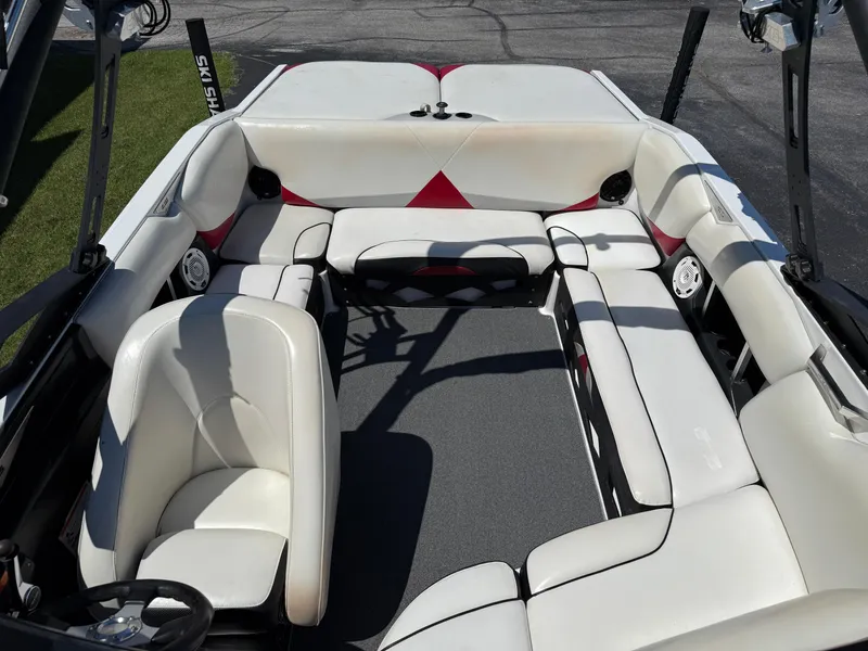Slide: The Image of 2011 Axis A22 boat interior with white seating and gray flooring. - 14