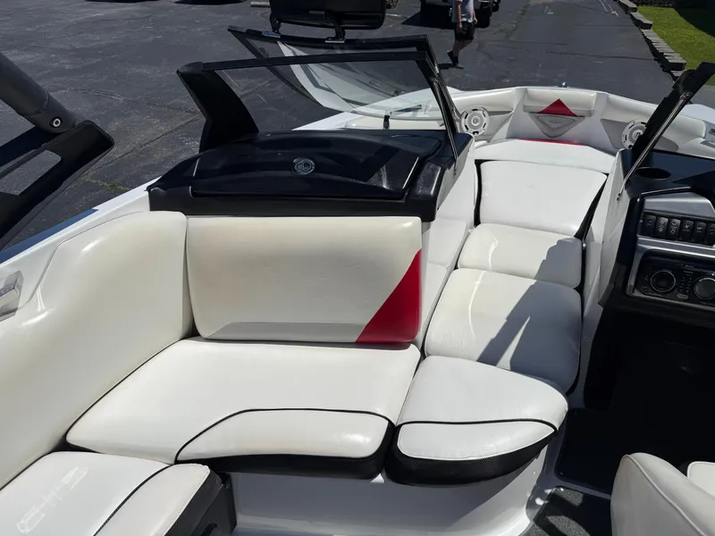 Slide: The Image of 2011 Axis A22 boat interior with white and red seating, open windshield, and control panel. - 15