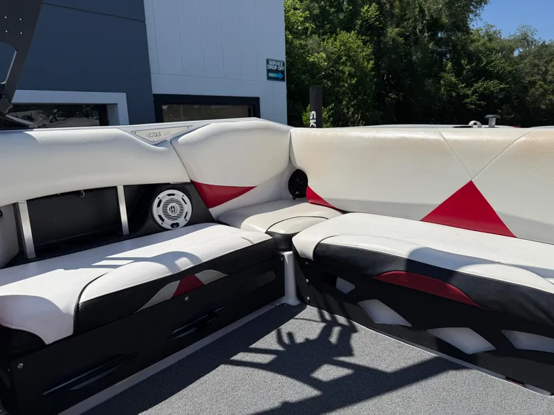 Slide: The Image of 2011 Axis A22 boat interior with white and red seating, speaker, and modern design. - 18