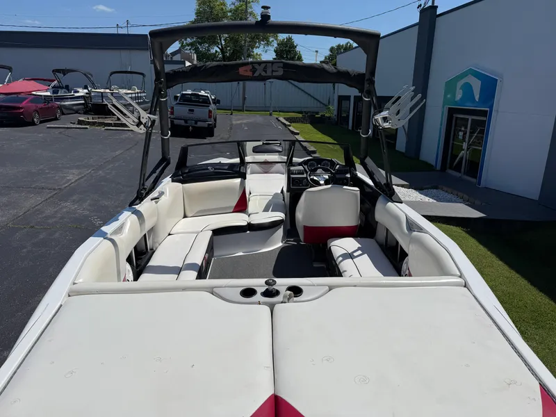 Slide: The Image of 2011 Axis A22 boat with spacious seating and sleek design, parked outdoors. - 8