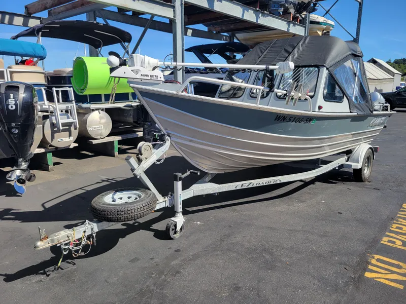 The Image of 2018 Klamath 18 OPW boat on trailer in a marina setting. - 1