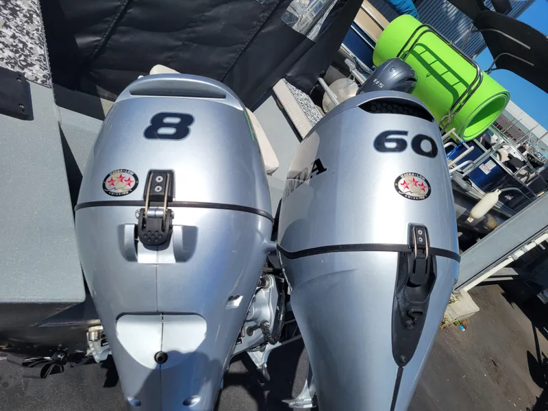 Slide: The Image of Two silver outboard motors, labeled 8 and 60, on a 2018 Klamath 18 OPW boat. - 11
