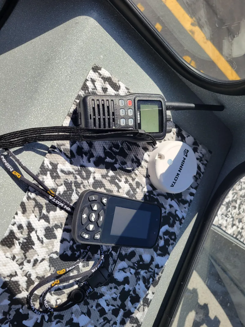 Slide: The Image of Electronics on a 2018 Klamath 18 OPW boat dashboard, including a radio and GPS device. - 16