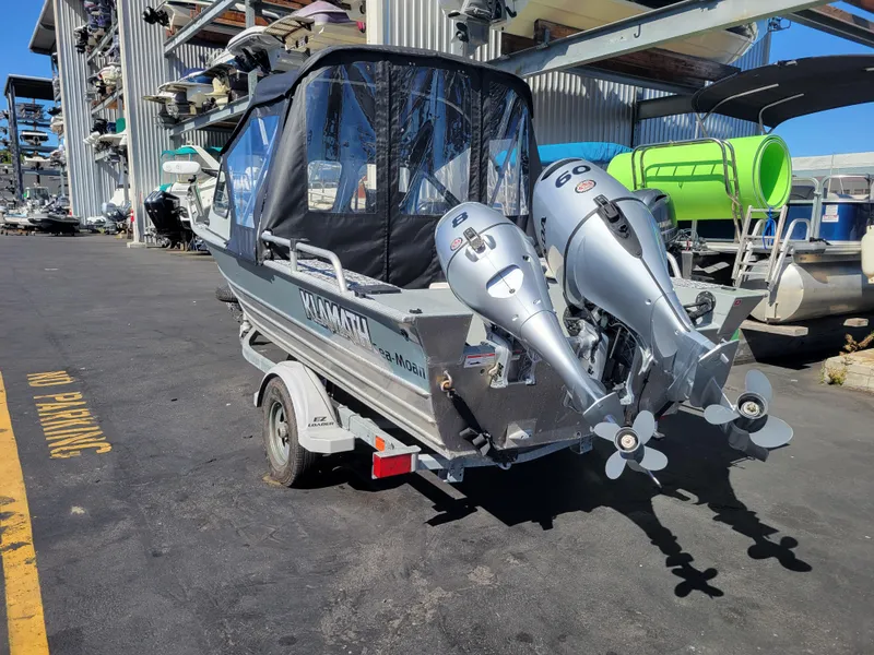 Slide: The Image of 2018 Klamath 18 OPW boat with dual outboard motors on a trailer. - 3