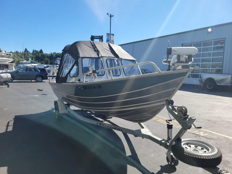 Slide: The Image of 2018 Klamath 18 OPW boat on trailer in sunny marina setting. - 7