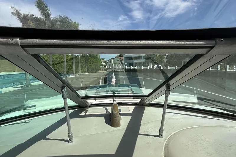 Slide: The Image of View from 2005 Sea Ray 340 Sundancer cockpit, showcasing marina and palm trees. - 17