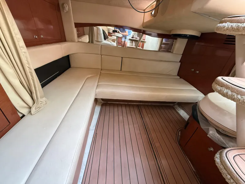 Slide: The Image of Interior of 2005 Sea Ray 340 Sundancer with beige seating and wooden flooring. - 21