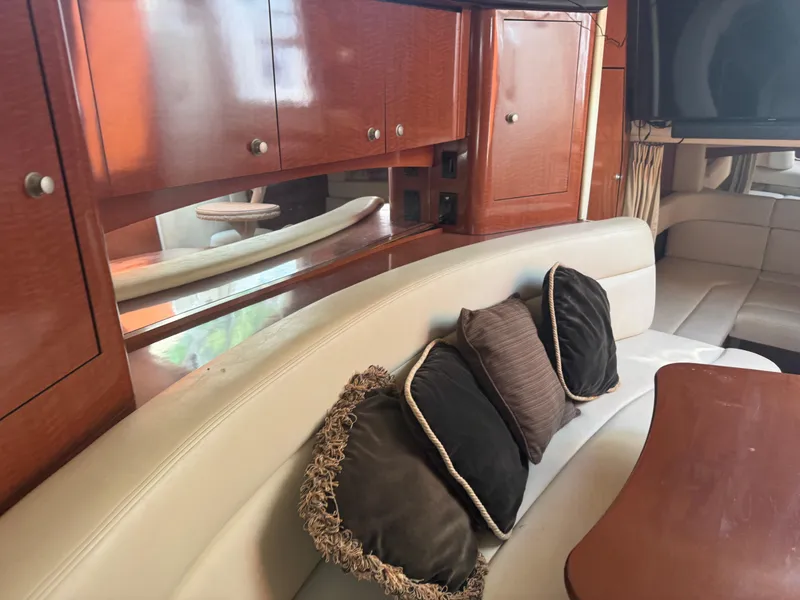 Slide: The Image of Interior of 2005 Sea Ray 340 Sundancer with plush seating and wooden cabinetry. - 23