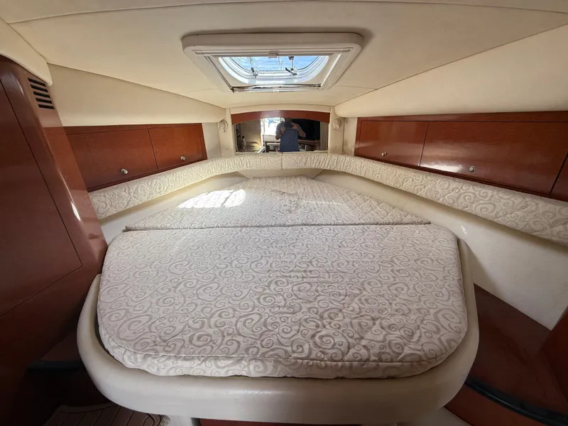 Slide: The Image of Interior cabin of 2005 Sea Ray 340 Sundancer with elegant bedding and wood cabinetry. - 27