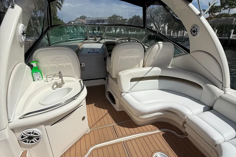 Slide: The Image of 2005 Sea Ray 340 Sundancer interior with white seating and wood flooring. - 3