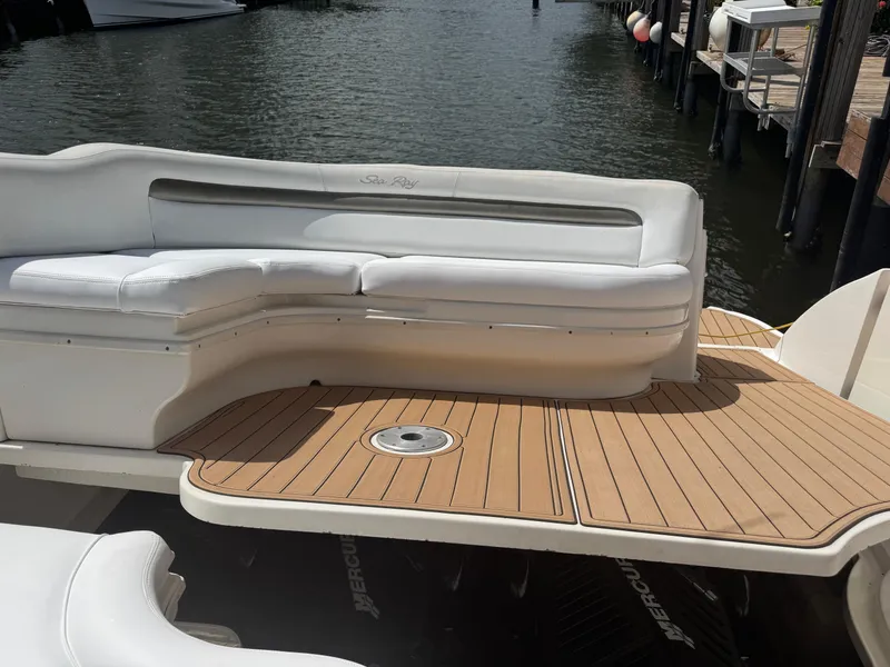 Slide: The Image of 2005 Sea Ray 340 Sundancer boat with white seating and teak deck at a marina. - 30
