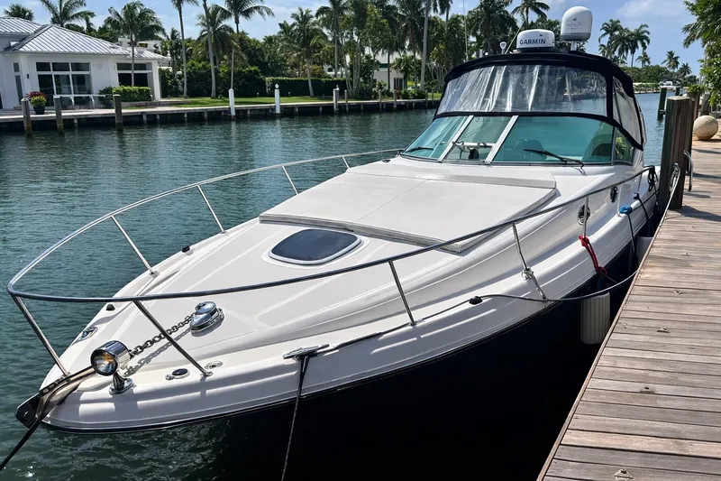 Slide: The Image of 2005 Sea Ray 340 Sundancer yacht docked by a waterfront home. - 35