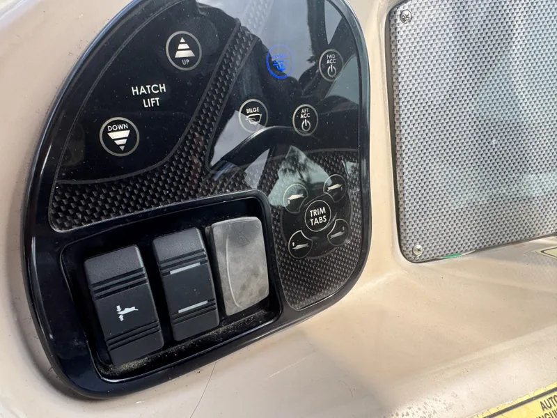 Slide: The Image of Control panel of a 2005 Sea Ray 340 Sundancer boat with various switches and buttons. - 6