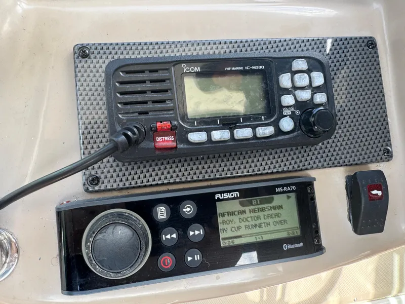 Slide: The Image of Boat dashboard with Icom VHF radio and Fusion MS-RA70 stereo on 2005 Sea Ray 340 Sundancer. - 8