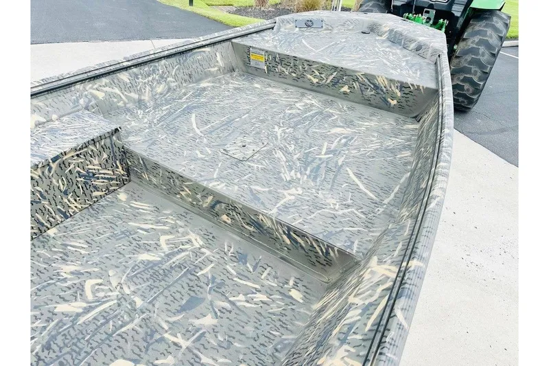 Slide: The Image of 2026 War Eagle 754LDV boat with camouflage pattern on a driveway. - 7