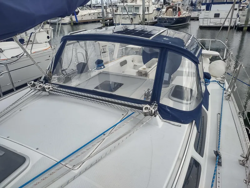 Slide: The Image of 2002 Catalina 36 MkII sailboat docked in marina, featuring blue canvas and rigging. - 15